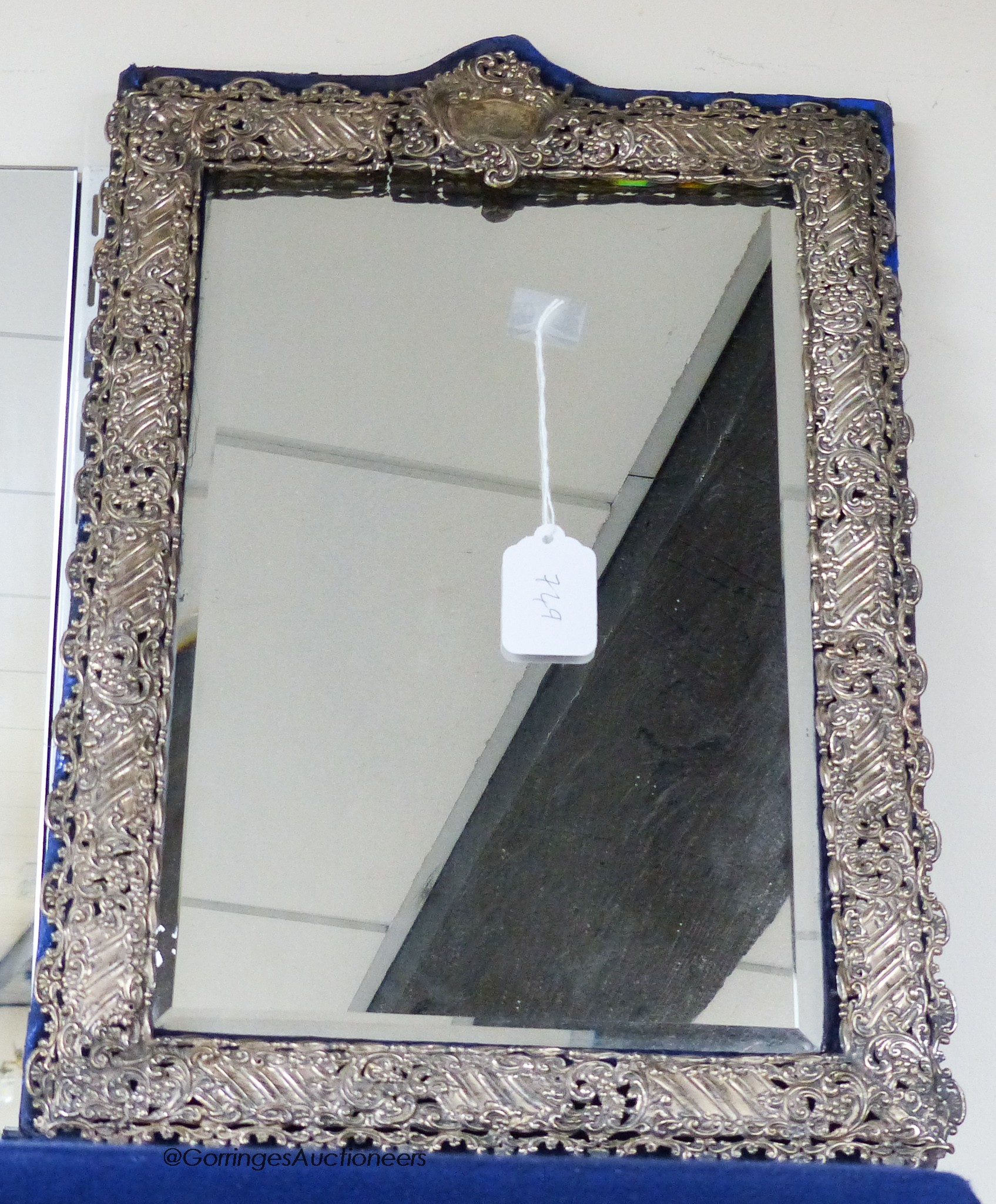 A large Edwardian repousse silver mounted easel mirror with pierced scrolling border, Henry Matthews, Birmingham, 1901, 48.7cm (mount loose).